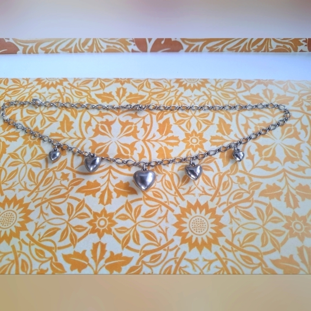 Silver tone necklace with heart charms